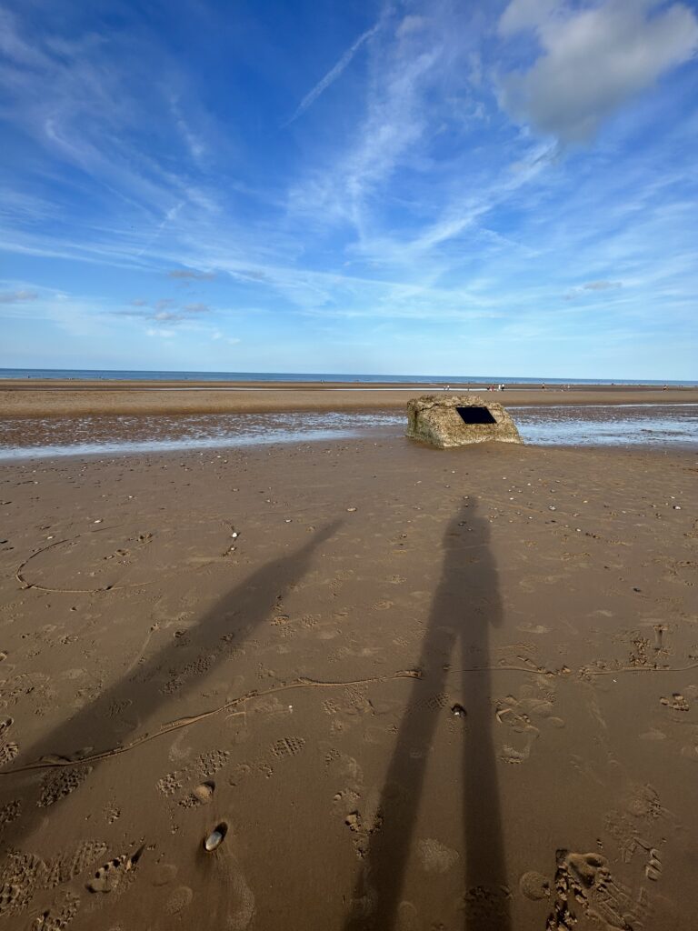 Lamberts rock, also known as Ray's Rock, a large rock siting on Omaha beach with black plaque commemorating the 1st Division medical staff that took shelter behind it to treat wounded soildiers.